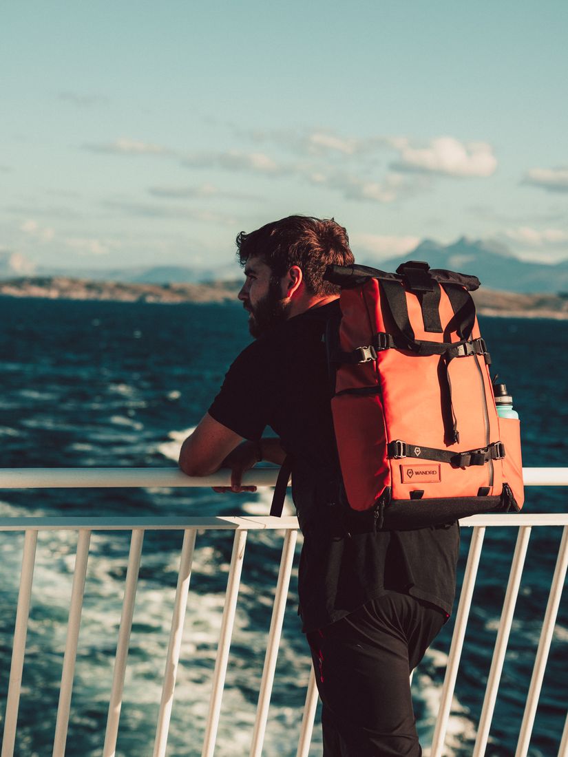 Greg with his camera backpack on a ferry