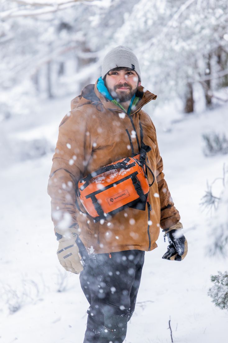 Greg in a snowy forest