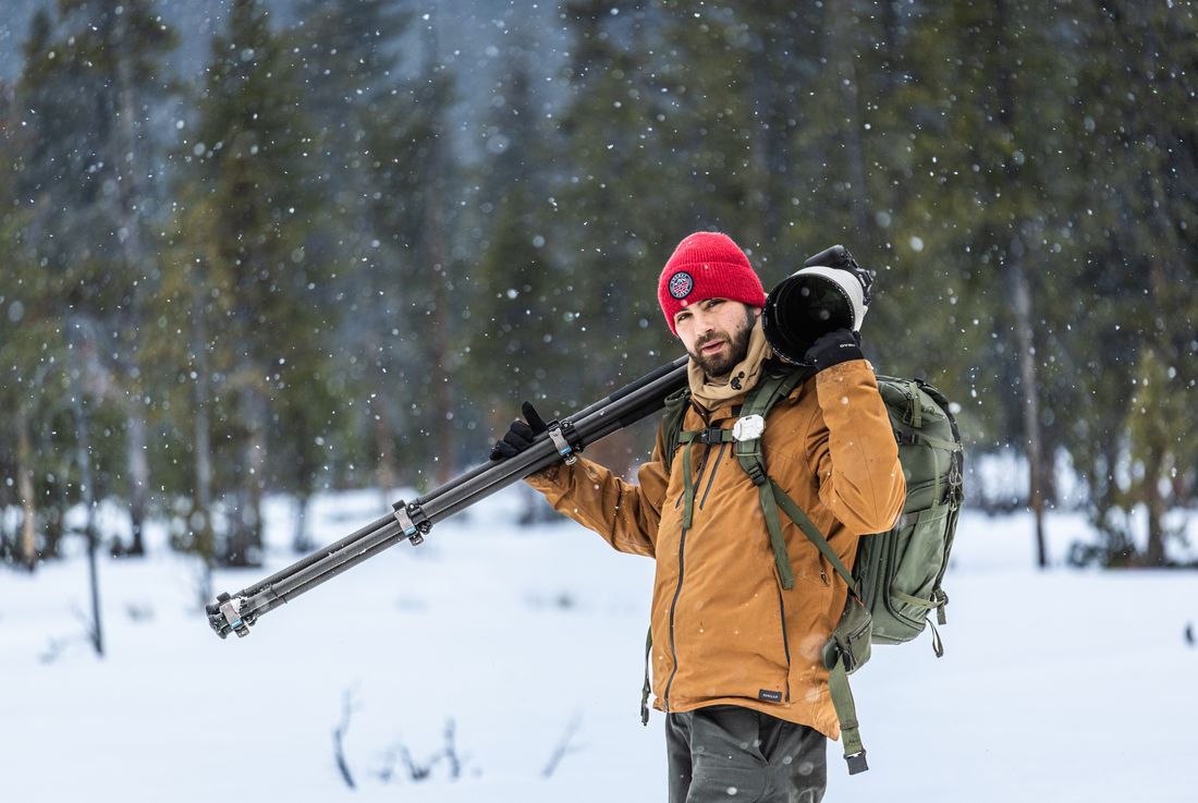 Greg with tripod and telephoto lens in Yellowstone